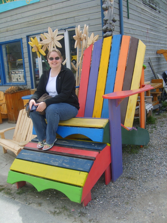 katherine in the big chair in front of the wood working shop